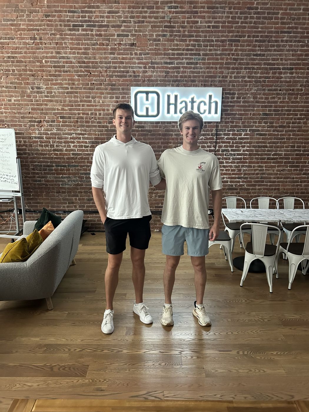 Cole with a fellow intern in front of the Hatch sign in the New York office